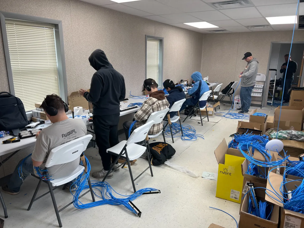 Technicians preparing network cabling and hardware for the new site